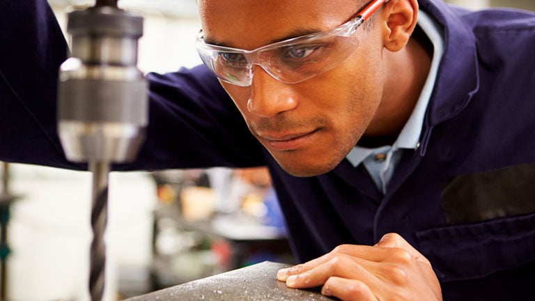 Close Up of Apprentice Engineer Using Milling Machine