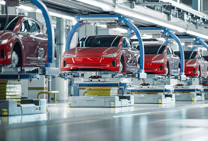 Vehicles on an assembly line.